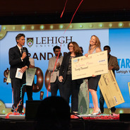 StartUp Lehigh Valley 2025 Winner holding a large check and surrounded by streamers